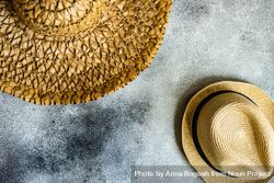 Top view of straw hats on grey counter 4mWDzW