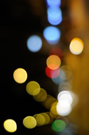 Blurry night lights along city street, vertical