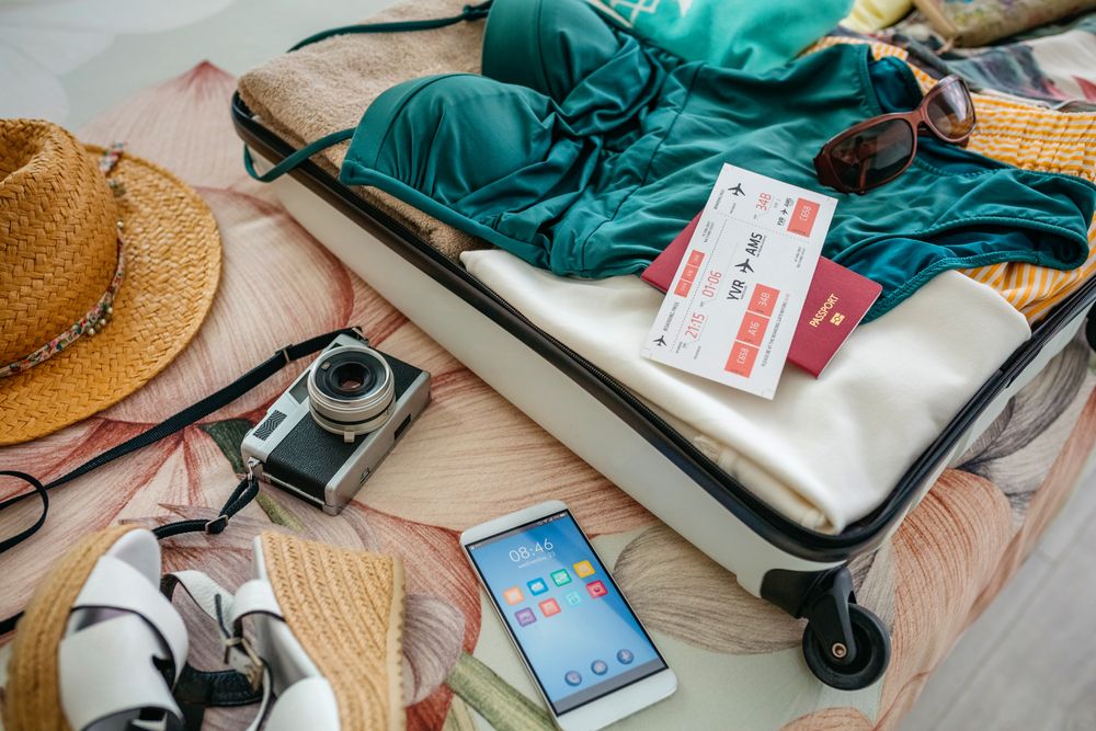 Open woman suitcase prepared for vacation