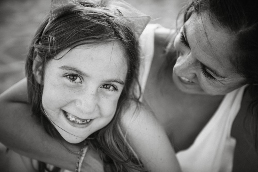 Woman with daughter on sunny beach