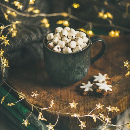 Hot chocolate with star cookies and festive decorations, square crop
