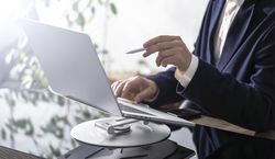 Businessman Working on Laptop at Office Desk