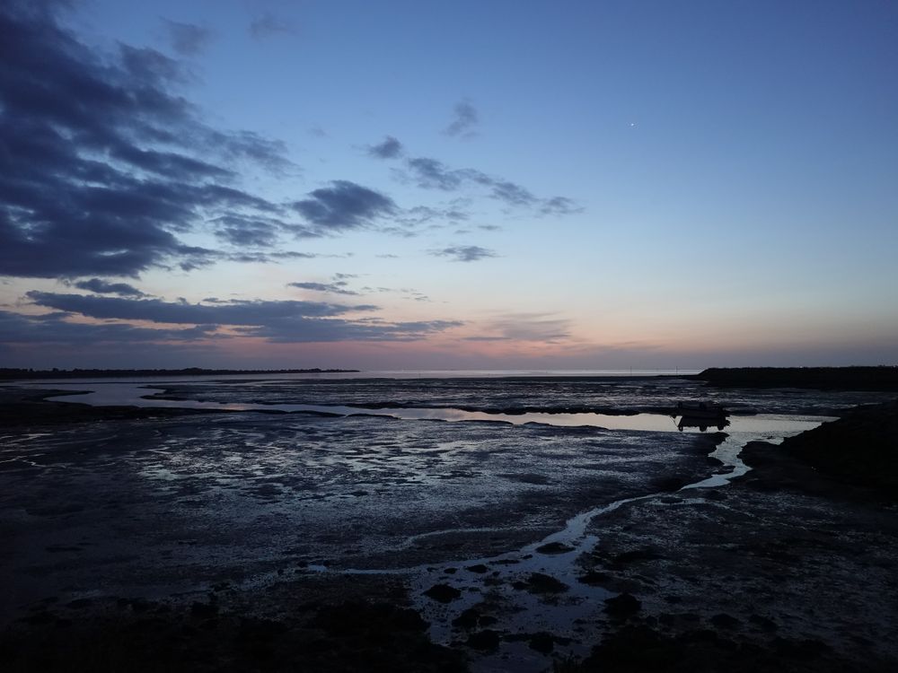Moored Boat at low tide at twilight