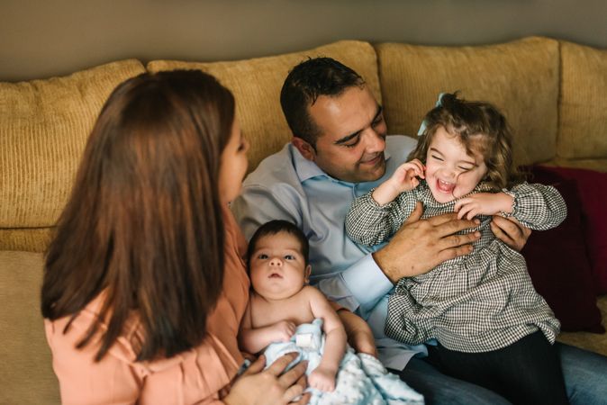 Happy family sitting on couch together