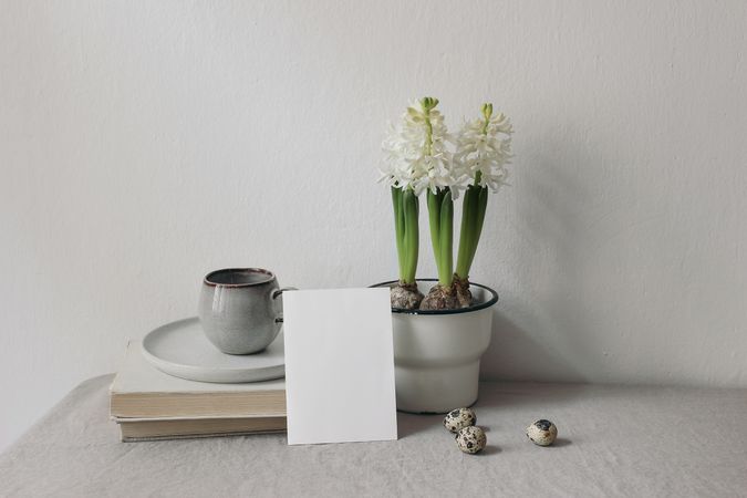 Cup of coffee, books. Linen table cloth.