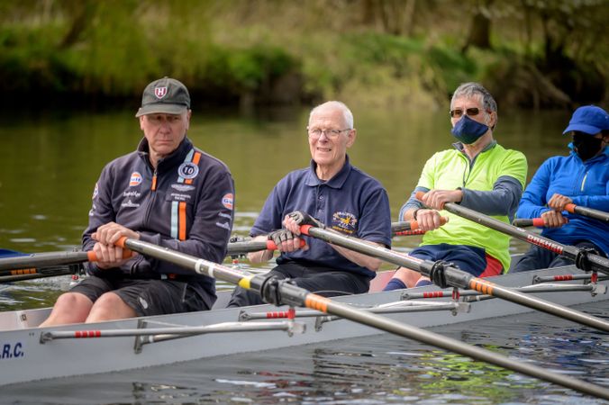 Men rowing together