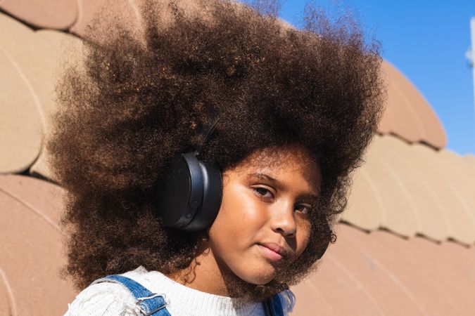 Black girl listening to music with headphones