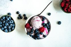 Top view of summer dessert with ice cream and berries