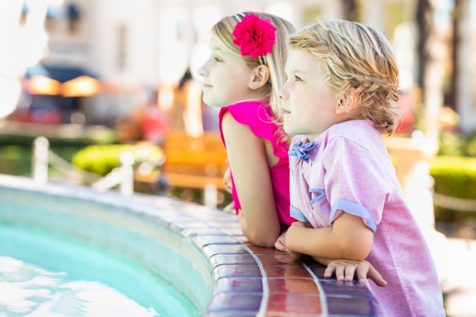 Cute Young Brother and Sister Enjoying The Fountain At The Park