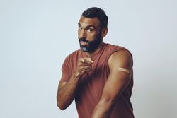 Man pointing at camera to encourage vaccinations, copy space