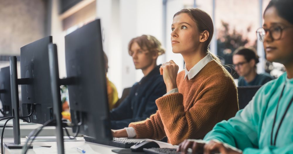 Young Smart Female Student Studying in Modern School with Diverse Multiethnic Classmates.
