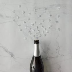 Champagne bottle with snow flakes on marble background