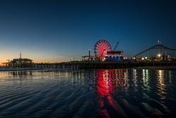 Santa Monica pier illuminated at dusk n56oe4