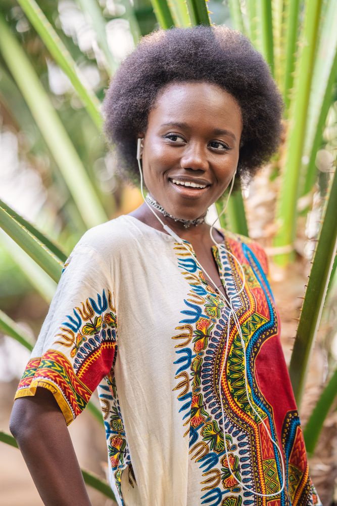 Smiling Black woman listening to music