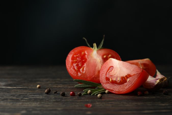 Tomatoes, pepper and rosemary on wooden table, close up