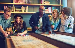 Multi-ethnic group of friends playing a bar game