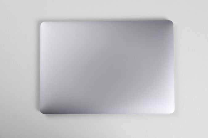 Top view of closed silver laptop on desk
