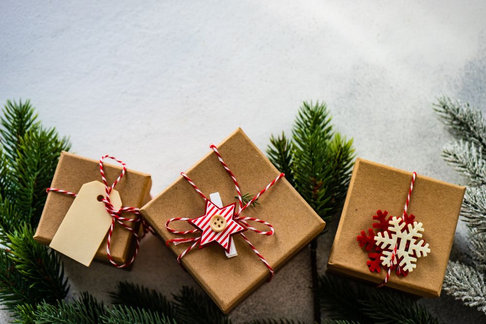 Three Christmas gifts with branch and copy space