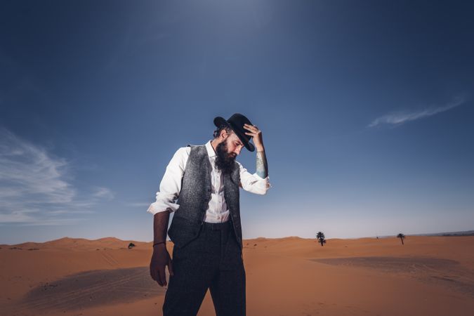 Bearded cowboy in desert