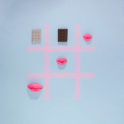 Tic-tac-toe of chocolate bars, hearts, doughnuts, cookies & hearts