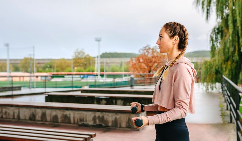 Young woman training with dumbbells