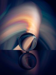 Crystal ball on board near abstract shines
