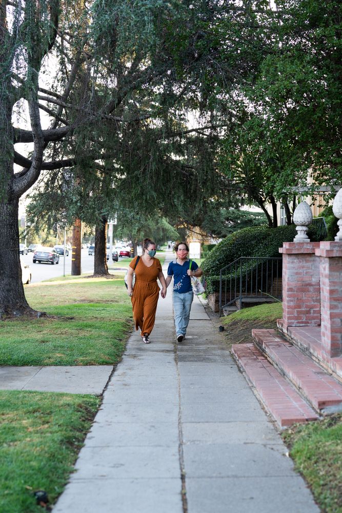 Happy romantic couple walking down street holding hands after shopping