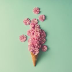 Ice cream cone with pink flowers and leaves