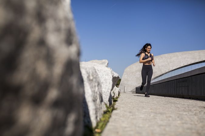 Woman running in park in sunny day