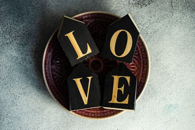 St. Valentine day card concept of the word love spelled out on plate