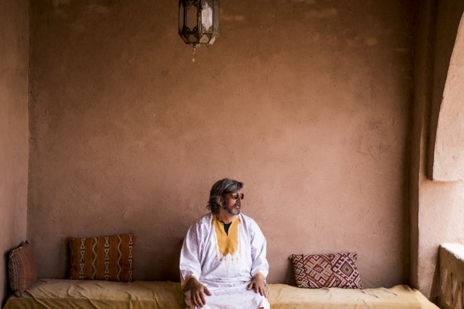 Man sitting on oriental stone terrace