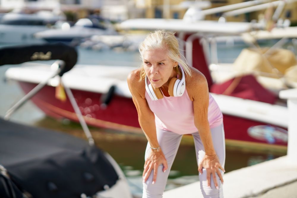 Mature sportswoman taking a break during exercise