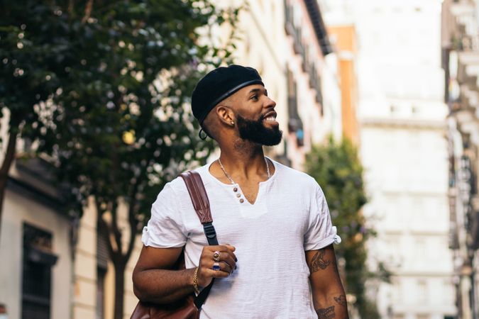 Stylish Black man walking on the city street