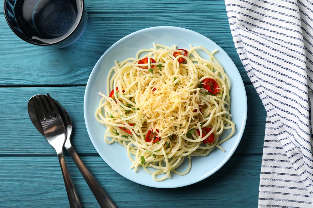 Composition with plate of tasty pasta on wooden background