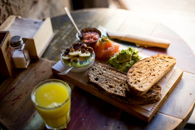Crunchy toast with avocado spread, tomato, fresh salmon and philadelphia cheese