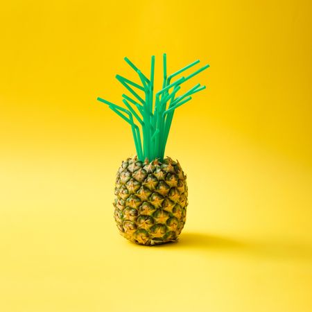 Pineapple with green straws in place of top