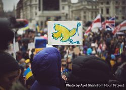 London, England, United Kingdom - March 5 2022: People holding a “peace” sign with bird 42OJdb