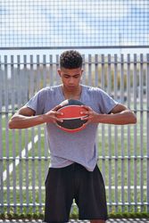 Portrait of young man with basketball