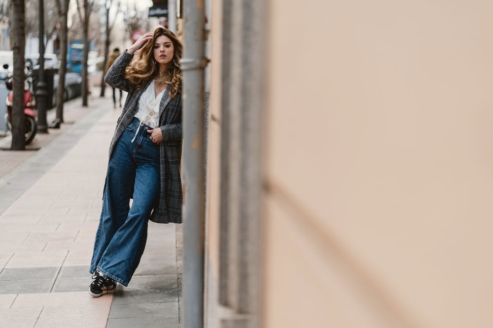 Woman leaning on wall on street