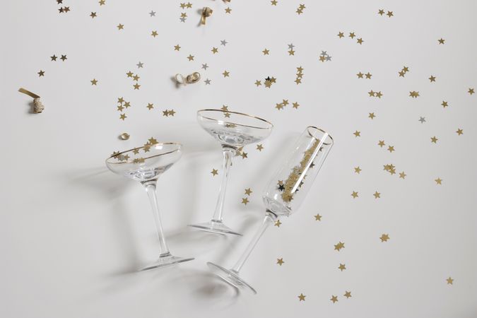 Flutes of champagne with golden confetti