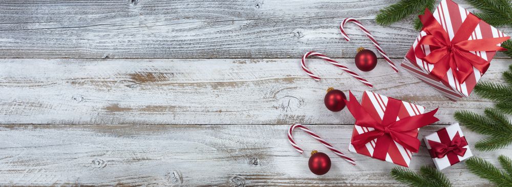 Merry Christmas right border with gifts and ornaments on weathered wooden background
