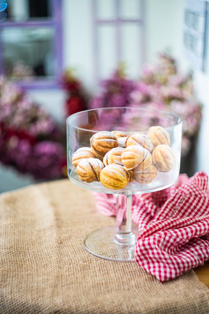 Christmas dessert concept with walnut shaped cookies stuffed with caramel cream