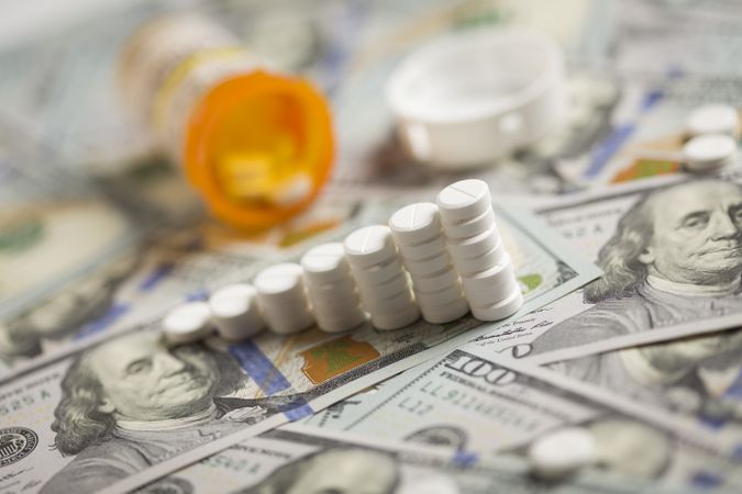 Medicine Pills Stacked on Newly Designed One Hundred Dollar Bills
