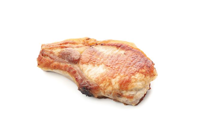 Fried pork steak isolated on light background. Grilled food