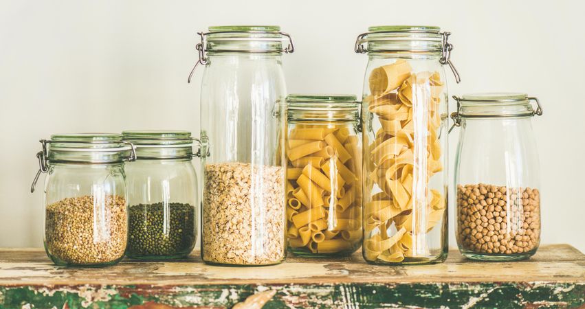 Variety of pasta, grains, and beans in glass jars