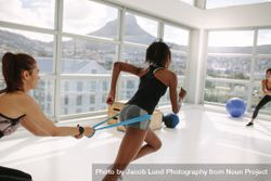 Women at gym during resistance band workout 5lVRym