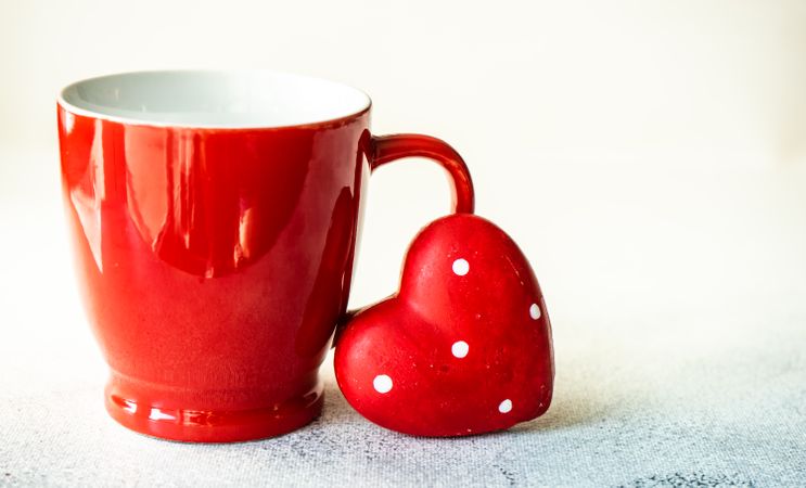 Red mug with dotted heart decoration for St. Valentine's day