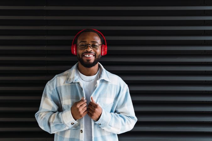 Smiling Black man in headphones and jacket