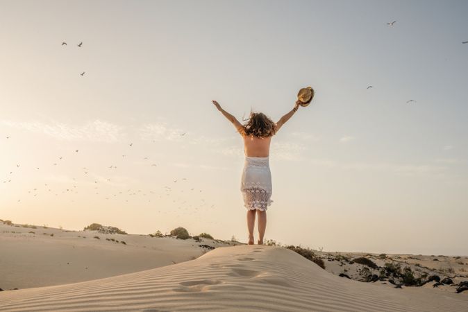 Active woman walking in dry desert barefoot