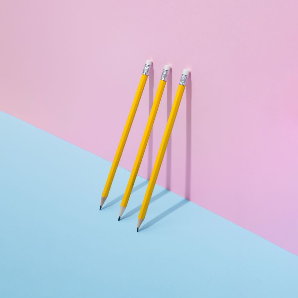 School pencils leaning on pastel background